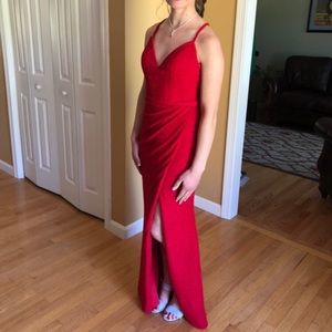 Sparkly red Jovani prom dress. It is a size 2 and has a slit on the left leg.